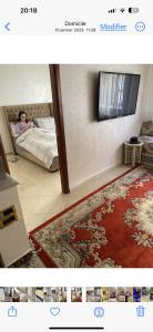 a child laying on a bed in a room with a rug at Charmant appartement in Casablanca