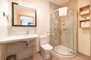 a bathroom with a toilet sink and a shower at Ignasiak Hotel in Września