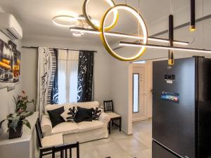 a living room with a couch and a chandelier at Ermina House in Skiathos
