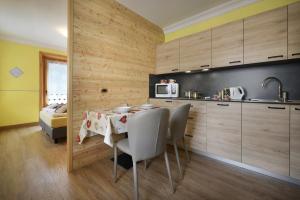 a kitchen with a table and chairs in a room at Baita La Fonte in Livigno +65 photos