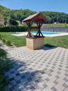 a gazebo sitting on a patio next to a pool at Motel Maks in Kiseljak