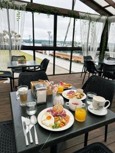 a table with plates of breakfast food on it at Old Mill Hotel in Klaipėda