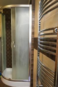 a shower with a glass door in a bathroom at Φιλόξενο Σπίτι in Nafplio +18 photos