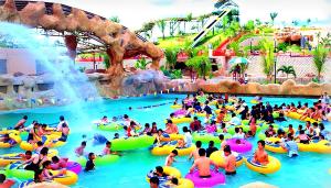 a large group of people in a water park at 2D Fantastic Villa Best HomeStay in Kampong Alor Gajah