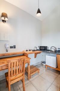a kitchen with a wooden bench and a counter at Altos da Mantiqueira Chalés -Grupo Vertentes in Santo Antônio do Pinhal +23 photos