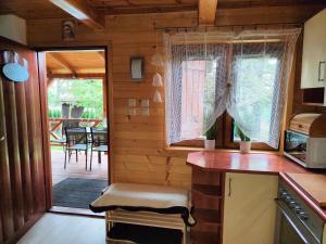 a kitchen with a counter and a table and chairs at Nowoczesny Domek Góralski in Kielce