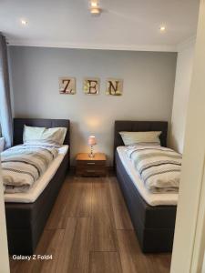 two beds sitting next to each other in a room at Ferienwohnung Rose in Wilhelmshaven