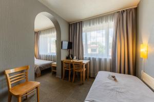 a hotel room with a bed and a table at Liva Hotel in Liepāja +194 photos