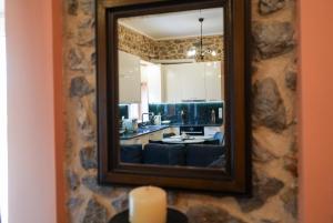a mirror on a wall in a living room at Φιλόξενο Σπίτι in Nafplio