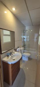 a bathroom with a sink and a toilet and a mirror at Hotel Molí Beach in Benidorm