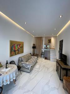 a living room with a couch and a table at Kali lux duplex in Kallithea Halkidikis