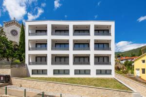 an image of a white apartment building at Belinda apartments with balcony in Opatija