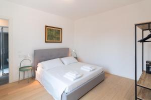 a bedroom with a bed with two towels on it at Palazzo delle Guglie by Postcardsfrom in Verona