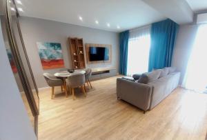 a living room with a couch and a table at Black Sea Luxury Apartament - Mamaia Nord Beachfront in Mamaia Nord +9 photos