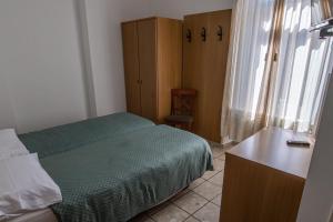 Letto o letti in una camera di Albergo Stazione