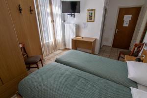 Letto o letti in una camera di Albergo Stazione