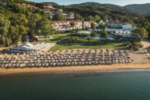 an aerial view of a beach with chairs and a resort at Princess Resort, Santikos Collection in Agia Paraskevi