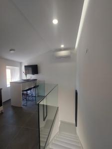 a room with a glass table and a desk at Apartments R&B in Baška