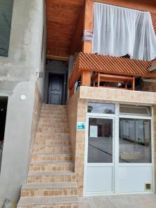 a set of stairs leading to a door with a glass at DOBRA GAZDA - transit sleep in Dobra