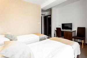 Postel nebo postele na pokoji v ubytování Hotel Šariš