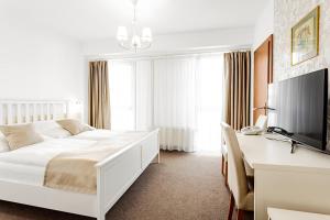 Postel nebo postele na pokoji v ubytování Hotel Šariš