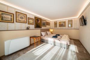 a room with two beds and a table in it at Stella Guesthouse in Arbanasi