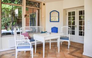 a porch with a white table and chairs at Lovely Home In Ystad With Sauna in Ystad