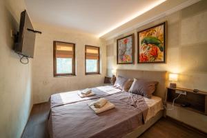 a bedroom with a bed with two towels on it at Stella Guesthouse in Arbanasi