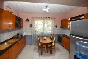 a kitchen with a table and chairs and a refrigerator at Fran's Traditional House in Shkodër