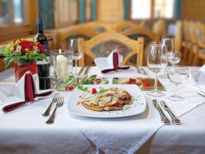 a table with a plate of food on a table at Gasthof Hirschen in Sibratsgfäll