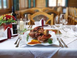 a table with a plate of food on a table at Gasthof Hirschen in Sibratsgfäll
