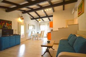 a living room with a couch and a table at Holiday Home Campo in Rovinj