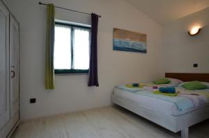 a bedroom with two beds and a window at Holiday Home Campo in Rovinj +25 photos