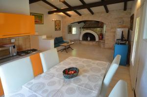 a kitchen and a table with a bowl of fruit on it at Holiday Home Campo in Rovinj