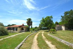 a dirt road in front of a house at Holiday Home Campo in Rovinj