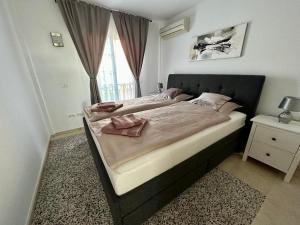 a bedroom with a large bed with two towels on it at Paraiso Ocean Panorama in Palm-Mar
