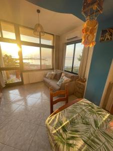 a bedroom with a bed and a living room with a couch at BeSanVito - Sea Apartments in Taranto