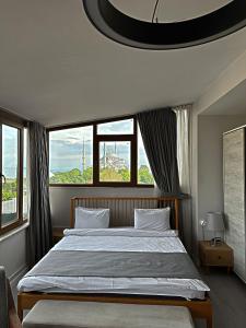 a bedroom with a large bed with a large window at Million Old City Apartment in Istanbul