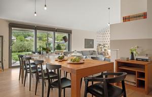 a kitchen and living room with a wooden table and chairs at Villa Poimon in Pićan