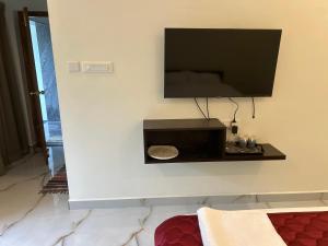 a flat screen tv hanging on a wall at Happy Nest Villa in Mahabalipuram