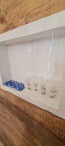 a display case with three boxes of cigarettes at Pousada Ágape duplo in Chapada dos Guimarães