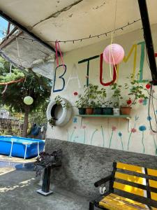 a wall with a bench and a sign that saysaba at Guest House Barbi in Batumi