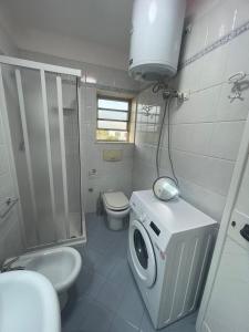 a bathroom with a toilet sink and a washing machine at BeSanVito - Sea Apartments in Taranto +22 photos