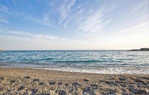 a sandy beach with the ocean in the background at 1 Bedroom Cozy Apartment In Longobardi in Longobardi