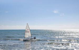 a person on a sail boat in the ocean at 1 Bedroom Cozy Apartment In Longobardi in Longobardi