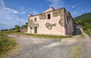 an old building with a painting on the side of it at 1 Bedroom Cozy Apartment In Longobardi in Longobardi