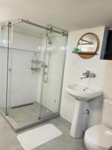 a bathroom with a shower and a toilet and a sink at Tbilisi Tower Apartment in Tbilisi City