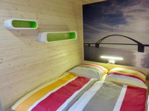 a bedroom with a bed in a wooden wall at Hausboot Fehmarn in Fehmarn