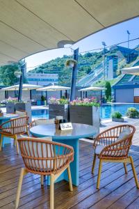a patio with two tables and chairs and a pool at SADU hotel in Almaty