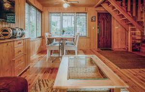 a dining room with a table and chairs in a cabin at Holiday Home Ostróda Rus Mala Ii in Ostróda +9 photos